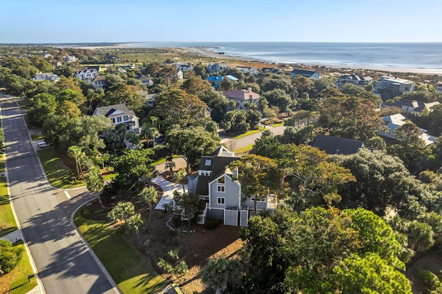 birds eye view of property featuring a water view and a beach view