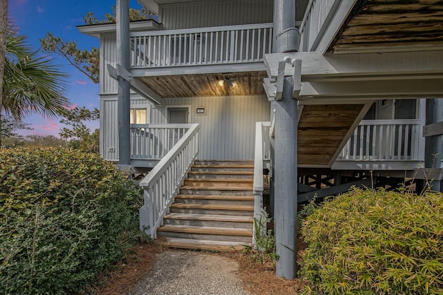 exterior entry at dusk with a balcony