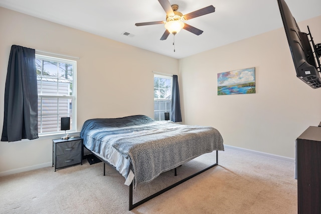 bedroom with light colored carpet and ceiling fan