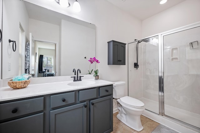 bathroom with vanity, tile patterned floors, toilet, and walk in shower