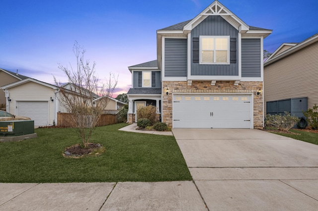 view of front of property featuring a garage and a yard