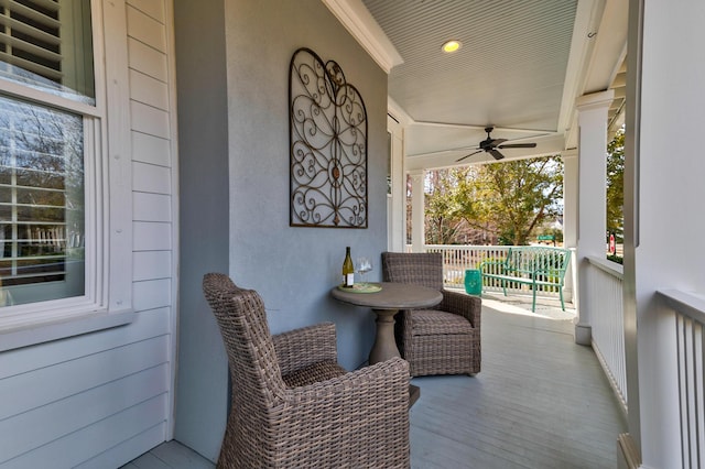 balcony with ceiling fan and a porch