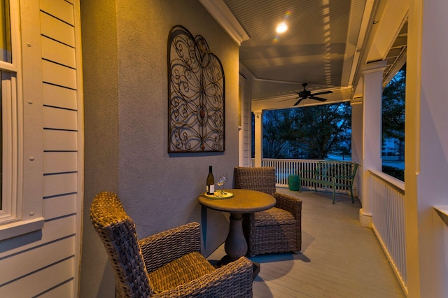 wooden deck with a porch and ceiling fan