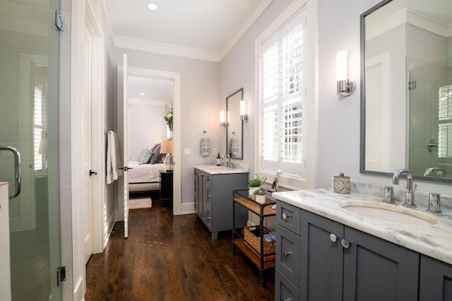 bathroom featuring connected bathroom, crown molding, a sink, and wood finished floors