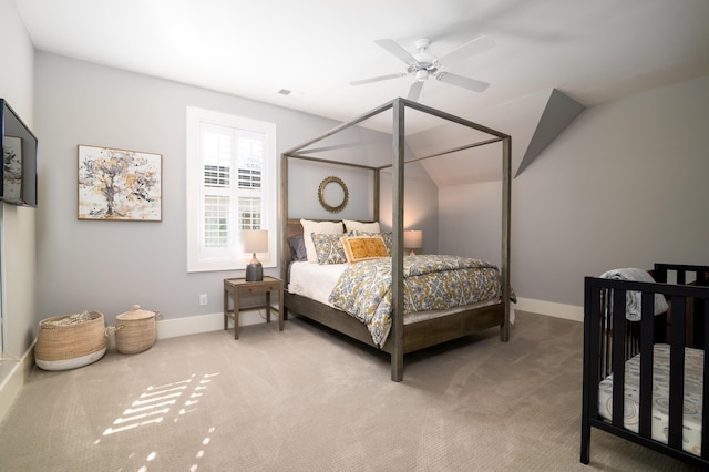 bedroom featuring lofted ceiling, carpet, visible vents, and baseboards