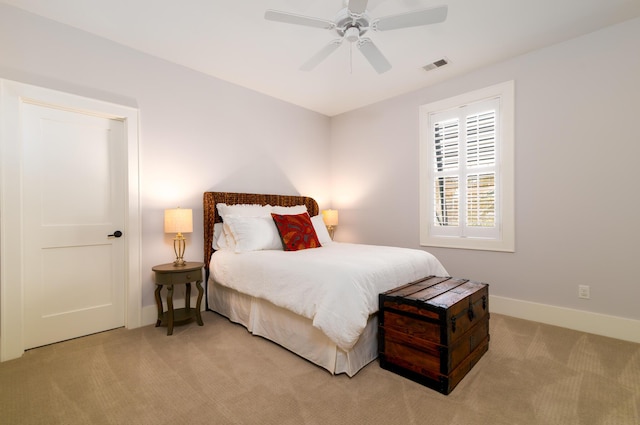 bedroom featuring light colored carpet, visible vents, ceiling fan, and baseboards