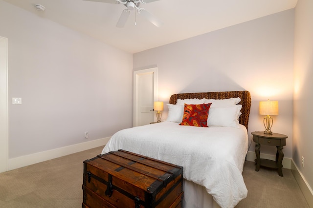 bedroom with light carpet, a ceiling fan, and baseboards