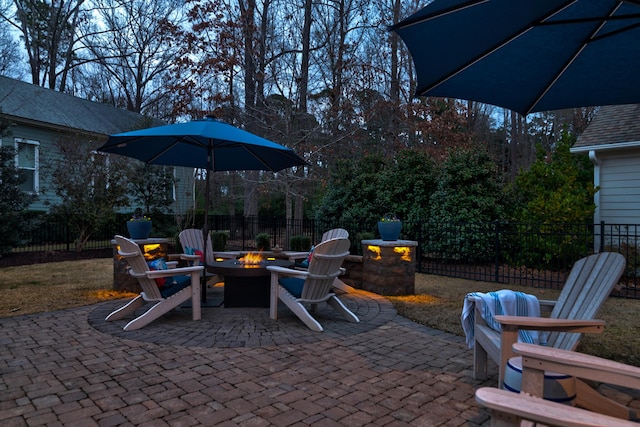 view of patio with an outdoor fire pit and fence