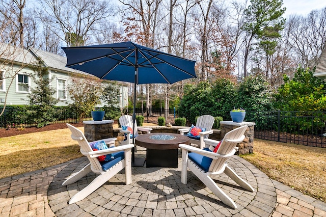 view of patio / terrace featuring an outdoor fire pit and fence