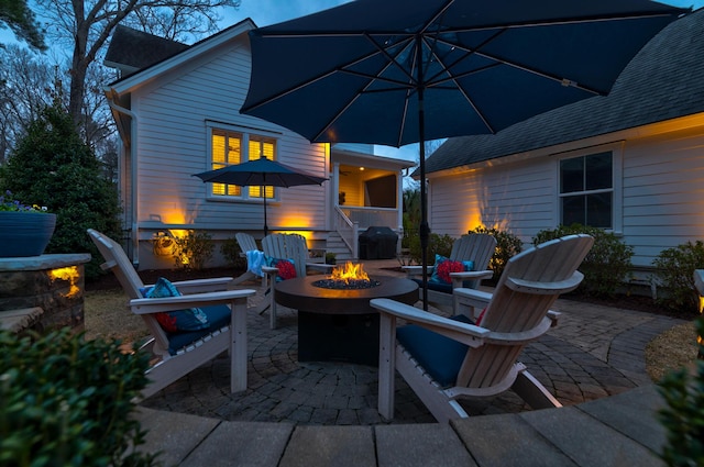 view of patio featuring a fire pit and a grill