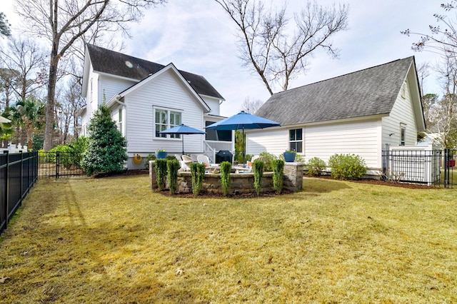 rear view of property featuring a fenced backyard, outdoor lounge area, a lawn, and roof with shingles