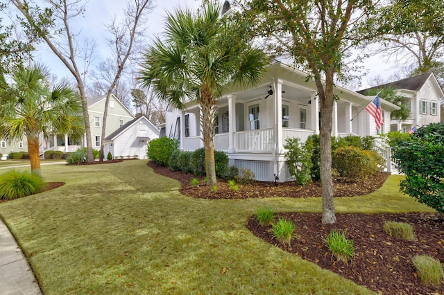 view of front of home with a porch, a front yard, and ceiling fan