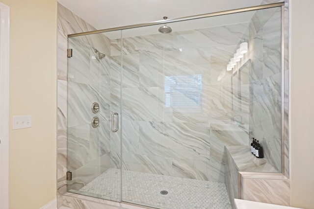 bathroom with a shower with shower door