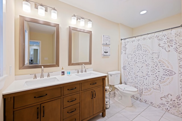 bathroom featuring vanity, toilet, and a shower with curtain