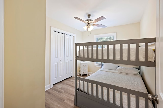 bedroom featuring a closet, light hardwood / wood-style floors, and ceiling fan