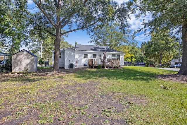 back of property with a yard, a deck, and central AC unit