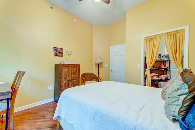 bedroom with wood finished floors, a ceiling fan, and baseboards