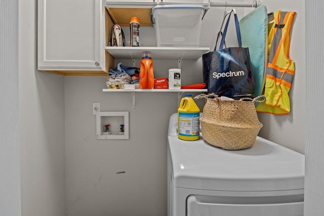 washroom featuring cabinet space and washer / clothes dryer