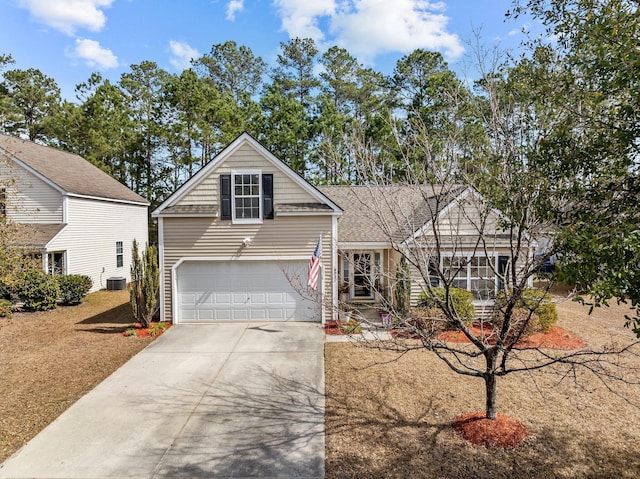 traditional home with a garage, driveway, and central air condition unit