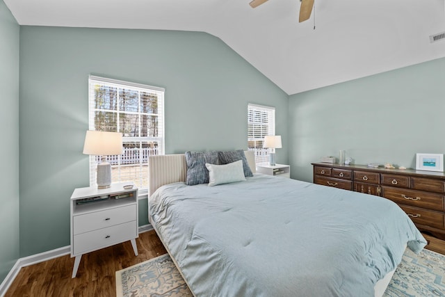 bedroom with lofted ceiling, visible vents, a ceiling fan, wood finished floors, and baseboards