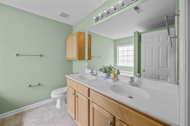 full bathroom with toilet, baseboards, visible vents, and a sink