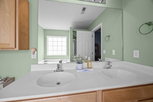 bathroom featuring double vanity, a sink, and visible vents