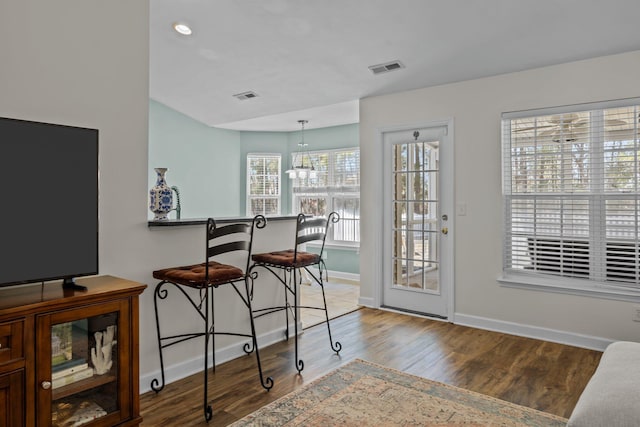 interior space featuring wood finished floors, visible vents, and baseboards