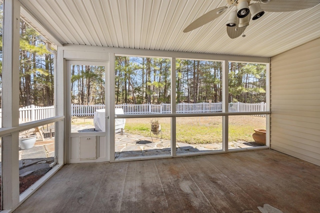 unfurnished sunroom with a ceiling fan