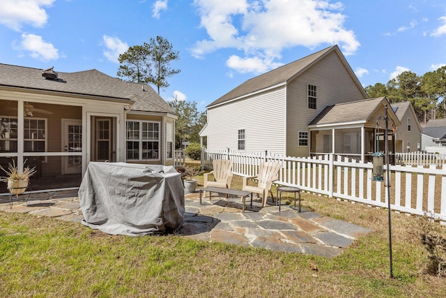 back of house featuring a sunroom, a patio area, and fence