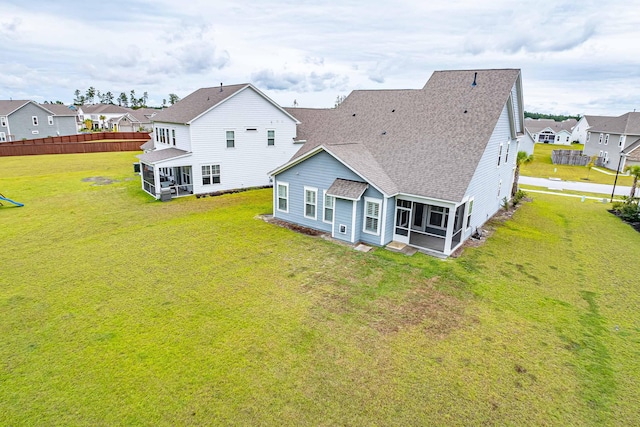 back of house with a lawn