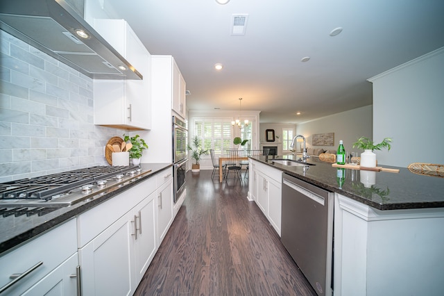 kitchen featuring stainless steel appliances, sink, wall chimney range hood, dark wood-type flooring, and a kitchen island with sink