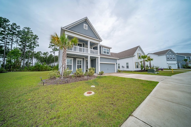 view of front of house with a garage, a front lawn, and covered porch