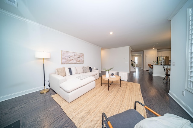 living room with ornamental molding and dark wood-type flooring