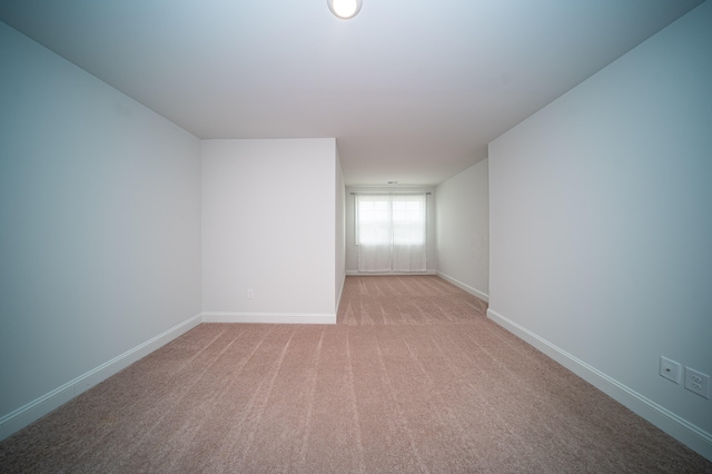 empty room featuring light carpet