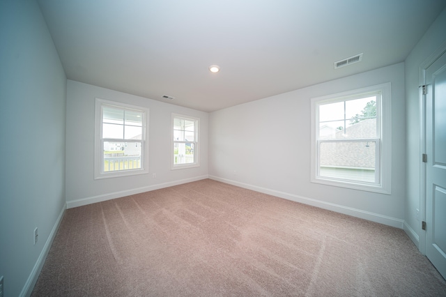 empty room featuring light carpet