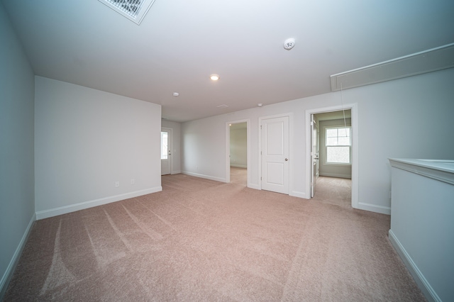 spare room featuring light colored carpet