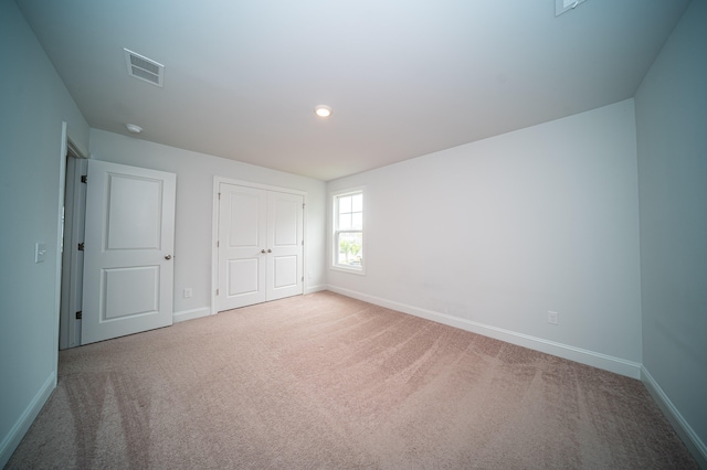 unfurnished bedroom featuring a closet and carpet floors