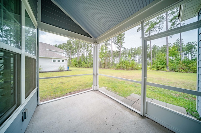 unfurnished sunroom featuring lofted ceiling