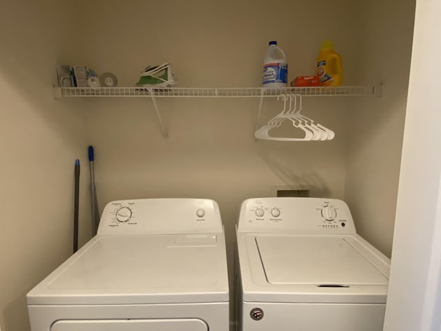 clothes washing area with washer and dryer