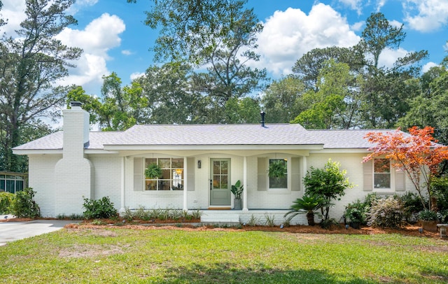 521 Carpenter St, Charleston, SC 29412 - ranch-style home with brick siding, a front lawn, a chimney, a porch, and roof with shingles