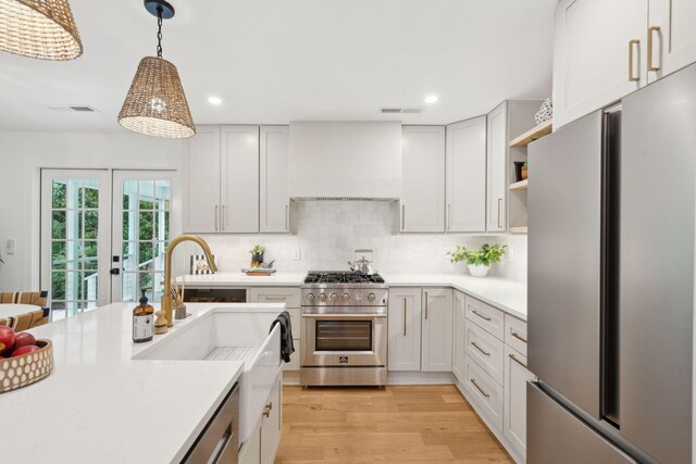 521 Carpenter St, Charleston, SC 29412 - kitchen with stainless steel appliances, light countertops, custom range hood, recessed lighting, and decorative backsplash