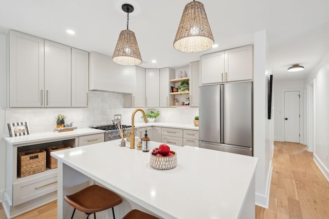 521 Carpenter St, Charleston, SC 29412 - kitchen featuring freestanding refrigerator, open shelves, custom exhaust hood, light wood-style flooring, and light countertops
