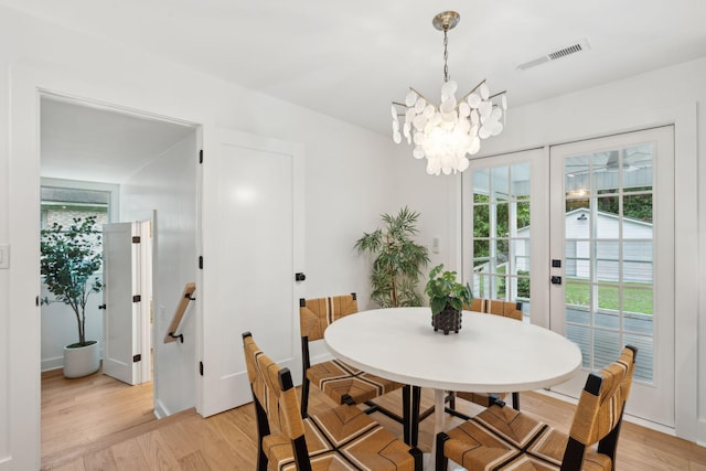 521 Carpenter St, Charleston, SC 29412 - dining area with light wood-type flooring and a chandelier