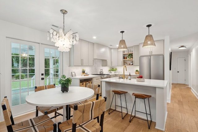 521 Carpenter St, Charleston, SC 29412 - kitchen featuring stainless steel appliances, open shelves, light countertops, backsplash, and premium range hood