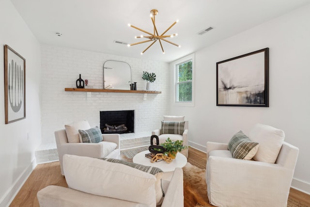 521 Carpenter St, Charleston, SC 29412 - living room with a chandelier, baseboards, a brick fireplace, and wood finished floors