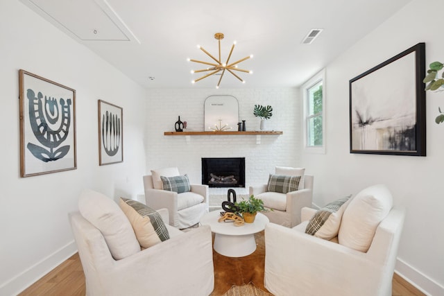 521 Carpenter St, Charleston, SC 29412 - living room with attic access, baseboards, a brick fireplace, and light wood-style floors