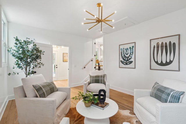 521 Carpenter St, Charleston, SC 29412 - living area with a chandelier, attic access, light wood-style floors, and baseboards