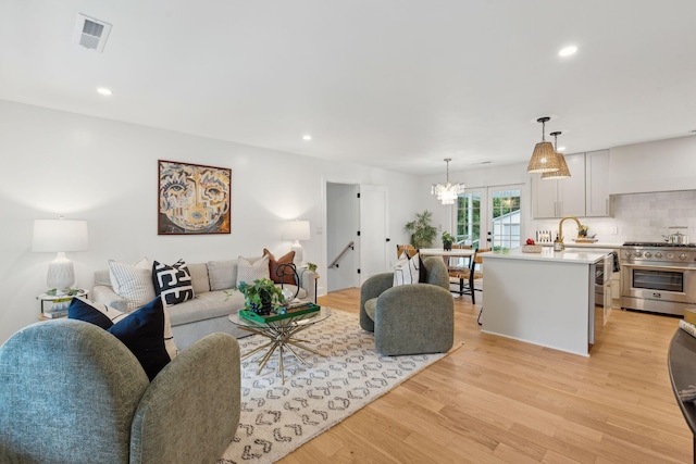 521 Carpenter St, Charleston, SC 29412 - living area featuring light wood finished floors, a chandelier, and recessed lighting