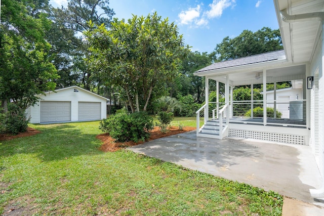 521 Carpenter St, Charleston, SC 29412 - view of grassy yard with a detached garage, an outdoor structure, and covered porch