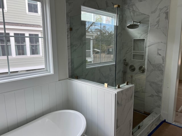 bathroom featuring shower with separate bathtub